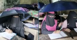 এক হাতে ছাতা, অন্য হাতে কলম, বৃষ্টির মধ্যেই পরীক্ষা দিলেন শিক্ষার্থীরা