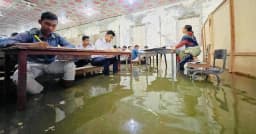 হাঁটু সমান পানির মধ্যেই পরীক্ষা দিলেন এসএসসি পরীক্ষার্থীরা