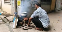 গ্যাস না থাকায় রাস্তার পাশে লাকড়ি দিয়ে রান্না